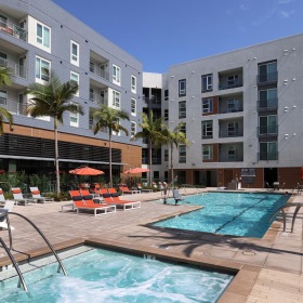 Shimmering resort-style pool a pool in a courtyard with buildings
