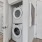 a room with a washing machine and a toilet